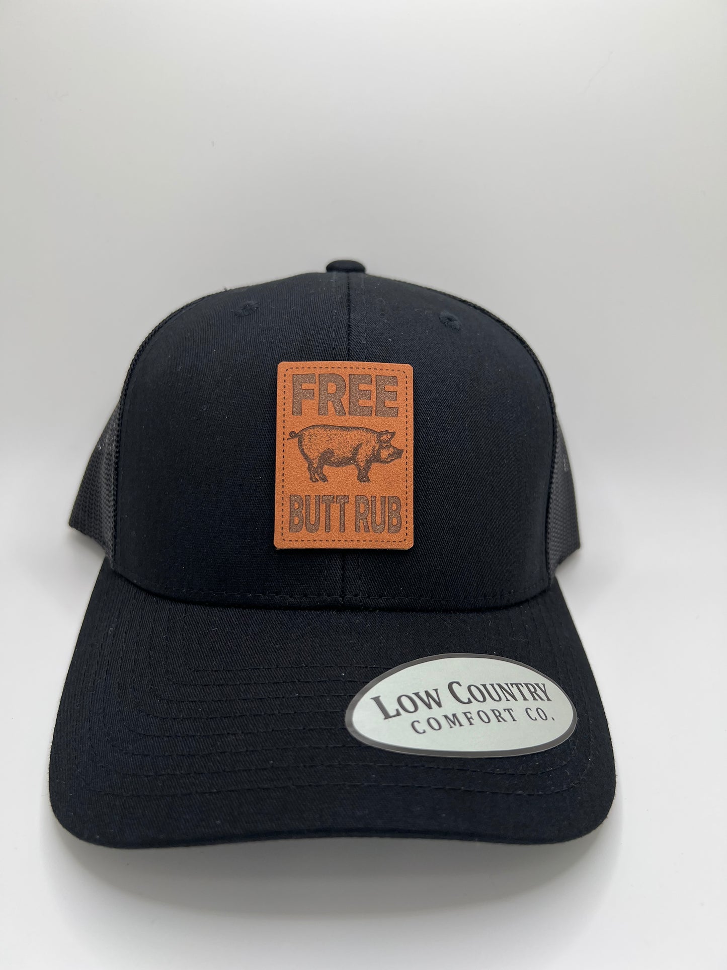 Free Butt Rub Leather Patch on a Solid Black Trucker Hat