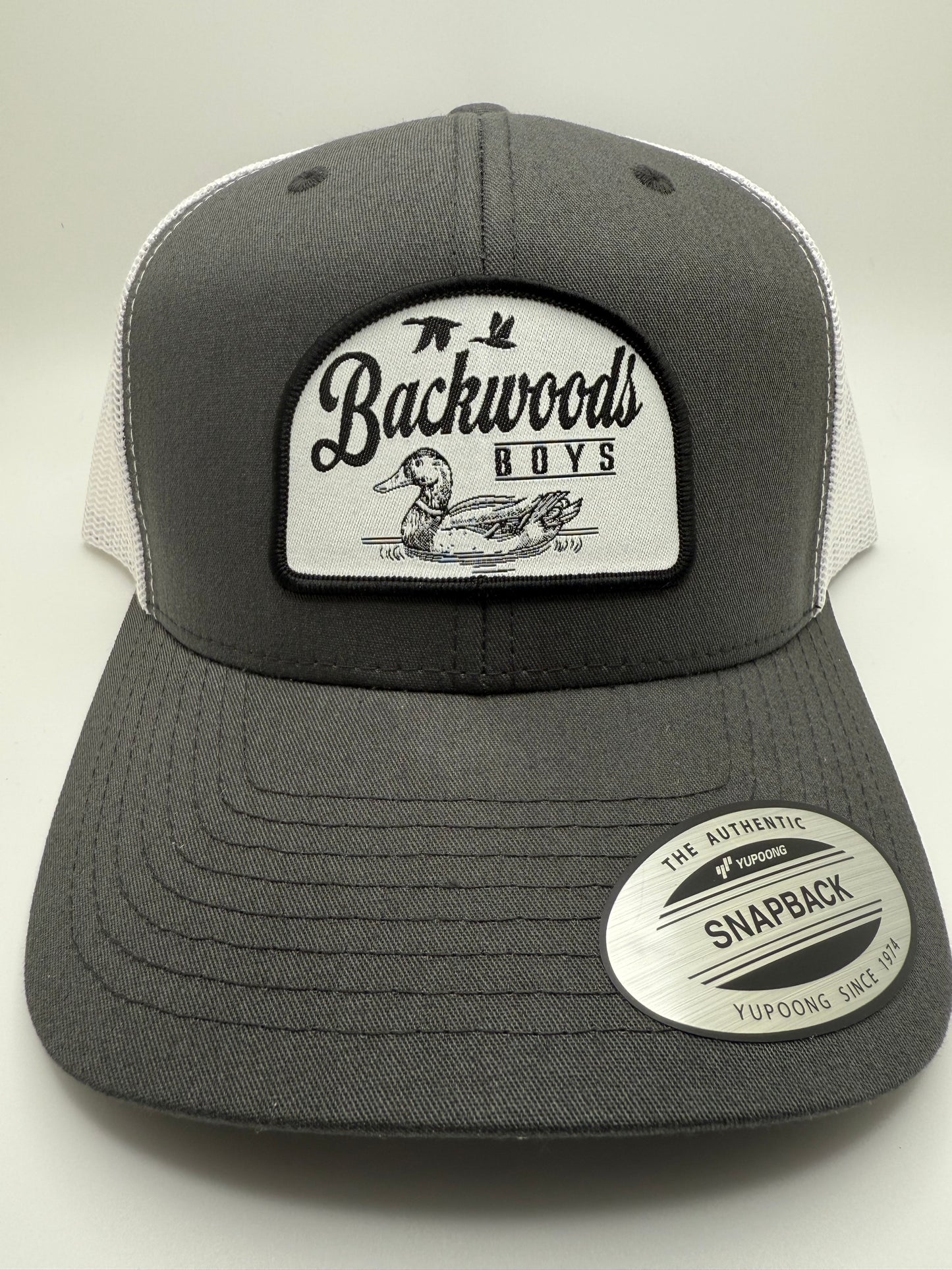 Backwoods Boys Floating Duck Sublimated Patch on a Charcoal/White Trucker Hat
