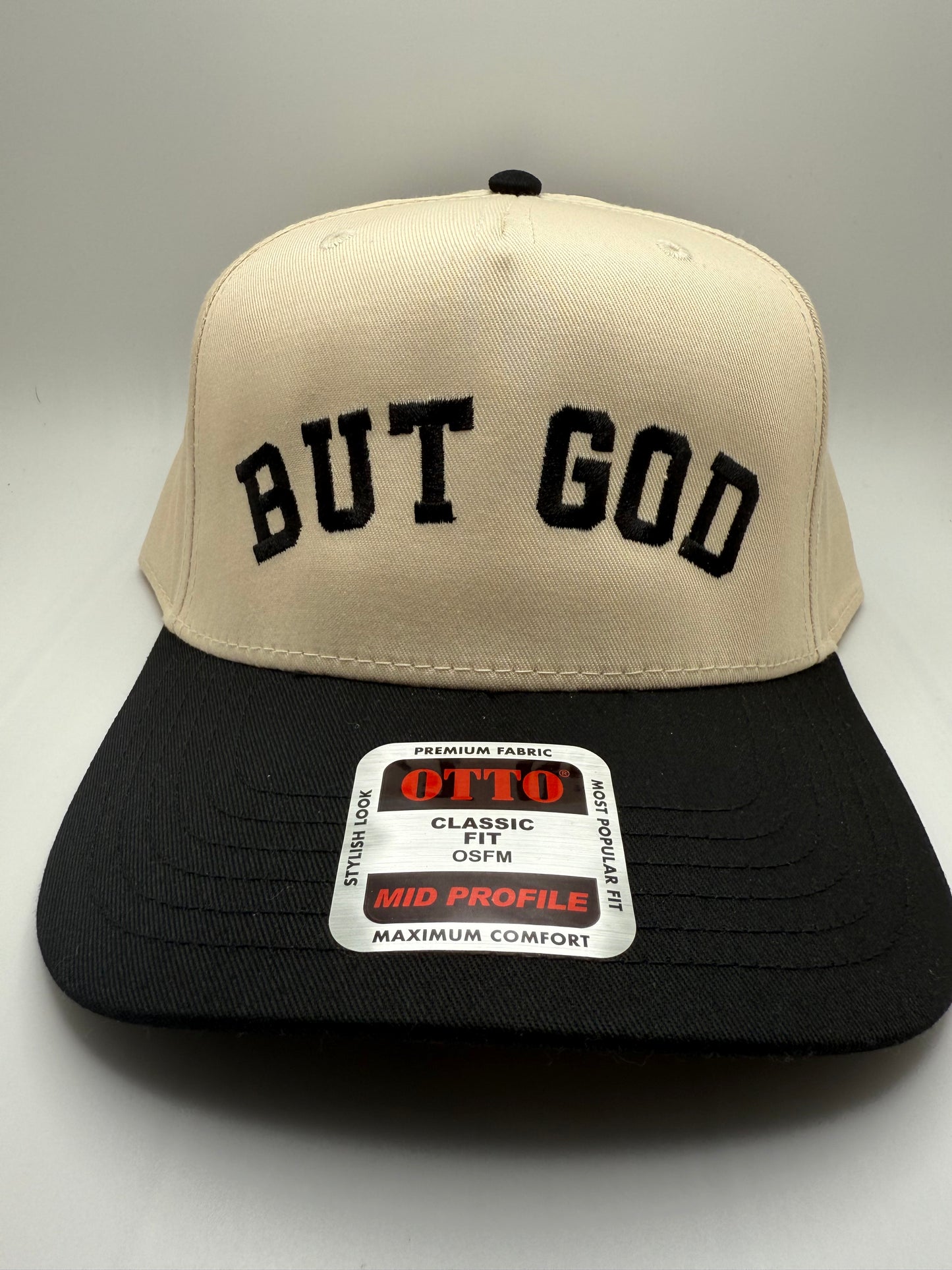 But God Embroidery on a Otto Natural/Black Hat