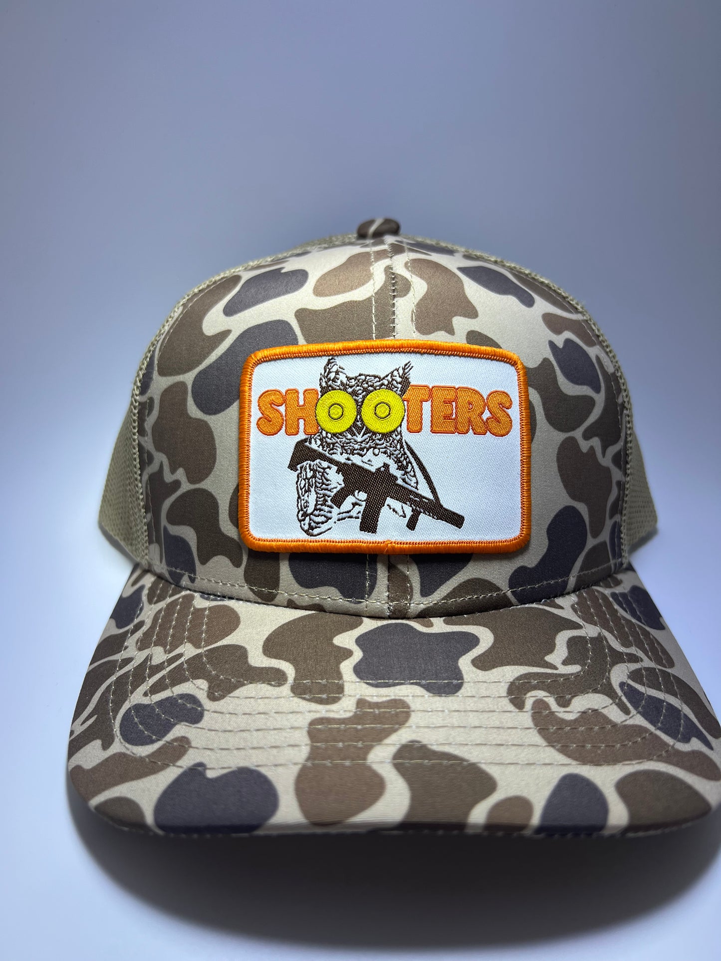 Shooters Sublimated Patch on a OS Camo/Brown RIverbed Threads Trucker Hat