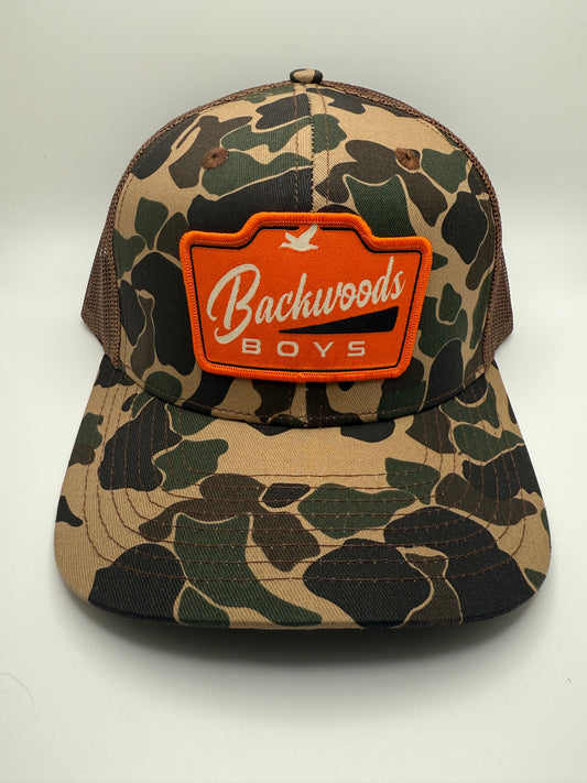 Backwoods Boys Orange Sublimated Patch on a OS Camo/Brown Trucker Hat