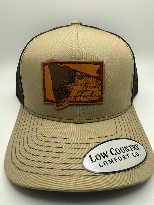 Local Hooker Leather Red Drum Tail Patch on a Khaki/Brown Trucker Hat